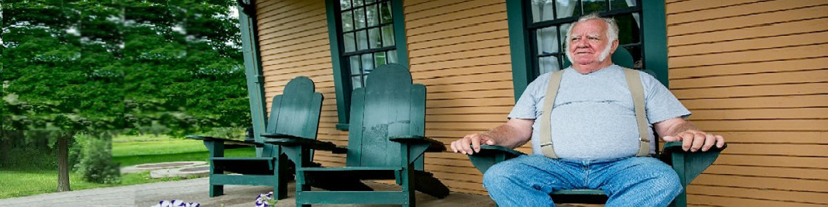Picture of a man sitting in a chair on the porch