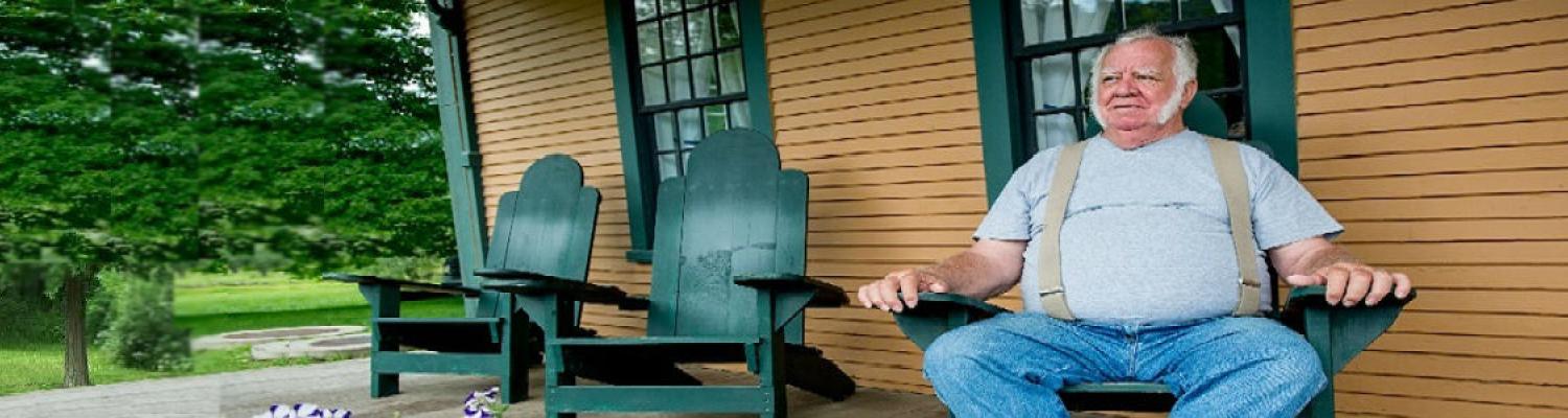 Picture of a man sitting in a chair on the porch